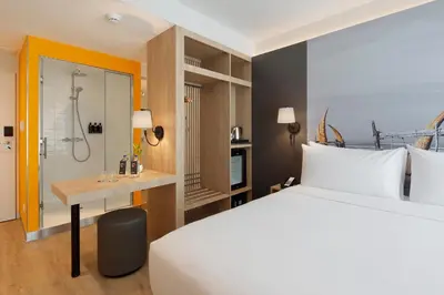 a hotel room with a bed and a shower at Ikonik Miraflores in Lima
