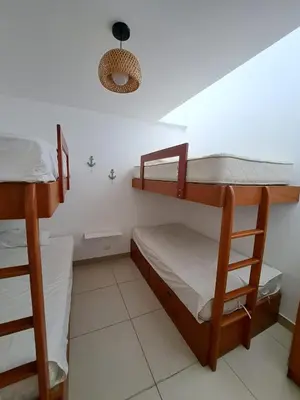 a bedroom with two bunk beds in a room at Alquilo casa de playa Condominio Playa Azul cerca de Asia in Cerro Azul