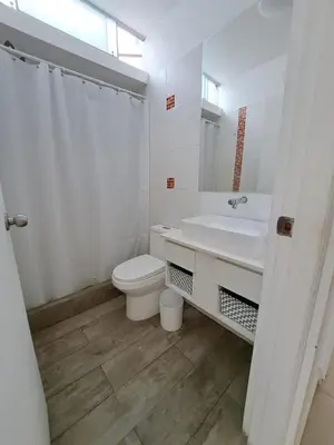 a white bathroom with a toilet and a sink at Alquilo casa de playa Condominio Playa Azul cerca de Asia in Cerro Azul