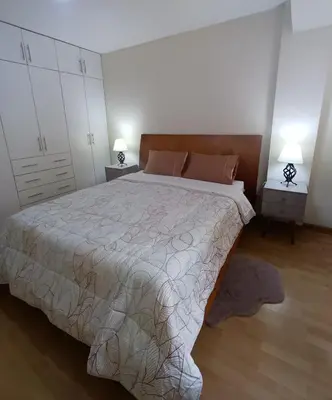 a bedroom with a large bed and two night stands at Miraflores View in Lima