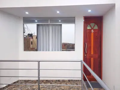 a balcony with a door and a window at Hospedaje Celerina & Elio in Lima