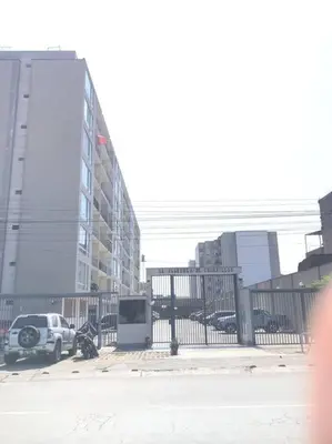 a car parked next to a fence in a city at 821 Céntrico Departamento en Chorrillos in Lima