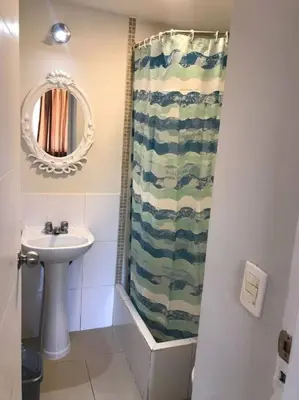 a bathroom with a sink and a shower curtain at 821 Céntrico Departamento en Chorrillos in Lima