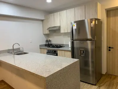 a kitchen with a stainless steel refrigerator and a counter at Apartamento en Miraflores con AC in Lima