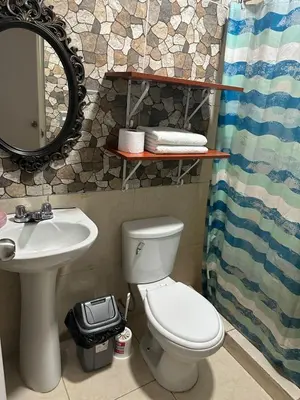 a bathroom with a toilet and a sink and a mirror at 595 Departamento en Chorrillos in Lima