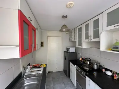 a small kitchen with a sink and a dishwasher at 595 Departamento en Chorrillos in Lima