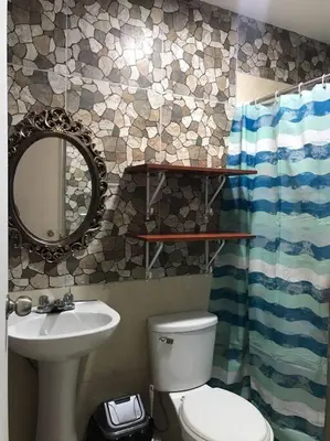 a bathroom with a toilet and a sink and a mirror at 595 Departamento en Chorrillos in Lima