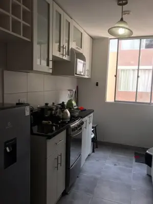 a kitchen with a sink and a stove top oven at 595 Departamento en Chorrillos in Lima