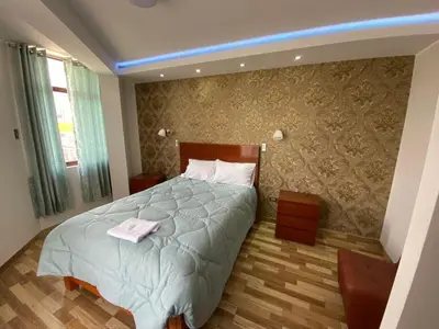 a bedroom with a bed with a towel on it at EL GRAN SEÑORIAL in Jauja