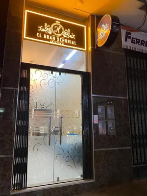 a store front with a glass door with a sign at EL GRAN SEÑORIAL in Jauja