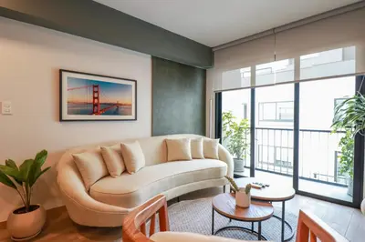 a living room with a couch and some windows at Colon by Wynwood House in Lima