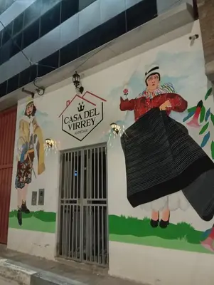a mural of a woman in a black dress on the side of a building at Casa del Virrey Hospedaje in Jauja