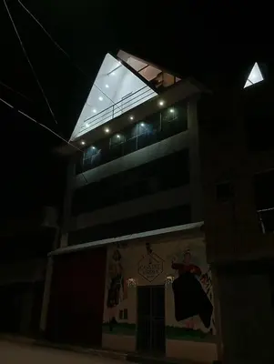 a building with a window on top of it at night at Casa del Virrey Hospedaje in Jauja