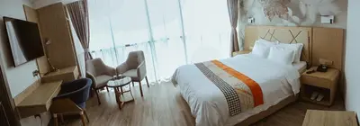 a hotel room with a bed and a large window at Gold Source Hotel in Lima