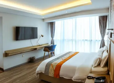 a hotel room with a bed and a desk and a television at Gold Source Hotel in Lima