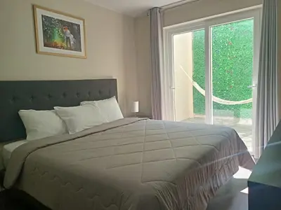 a bedroom with a large bed and a window at Hotel Nebai in Ica
